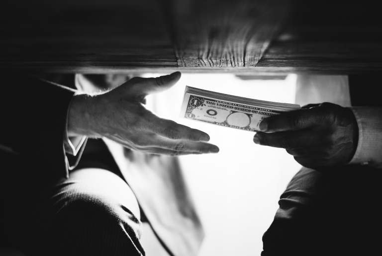 Bribery and corruption, as shown by this image of hands passing money under the table is what the BSP wants to prevent under the AFASA Law