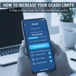 A man holds a mobile phone in front of a laptop to show how to increase your GCash limits