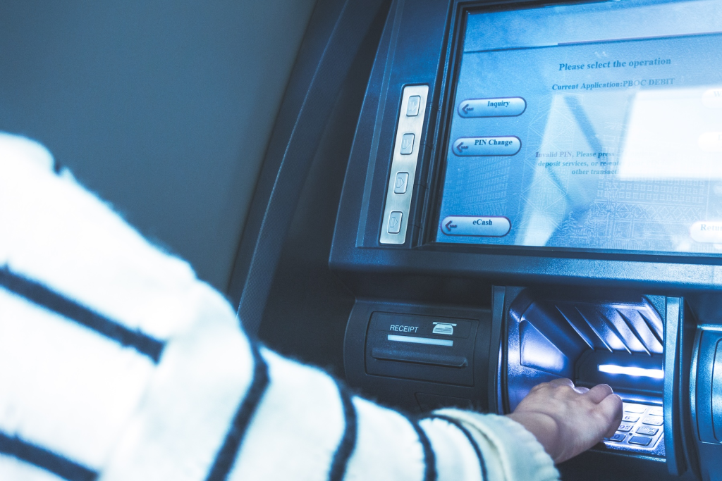 A person is shown here withdrawing cash from an ATM.