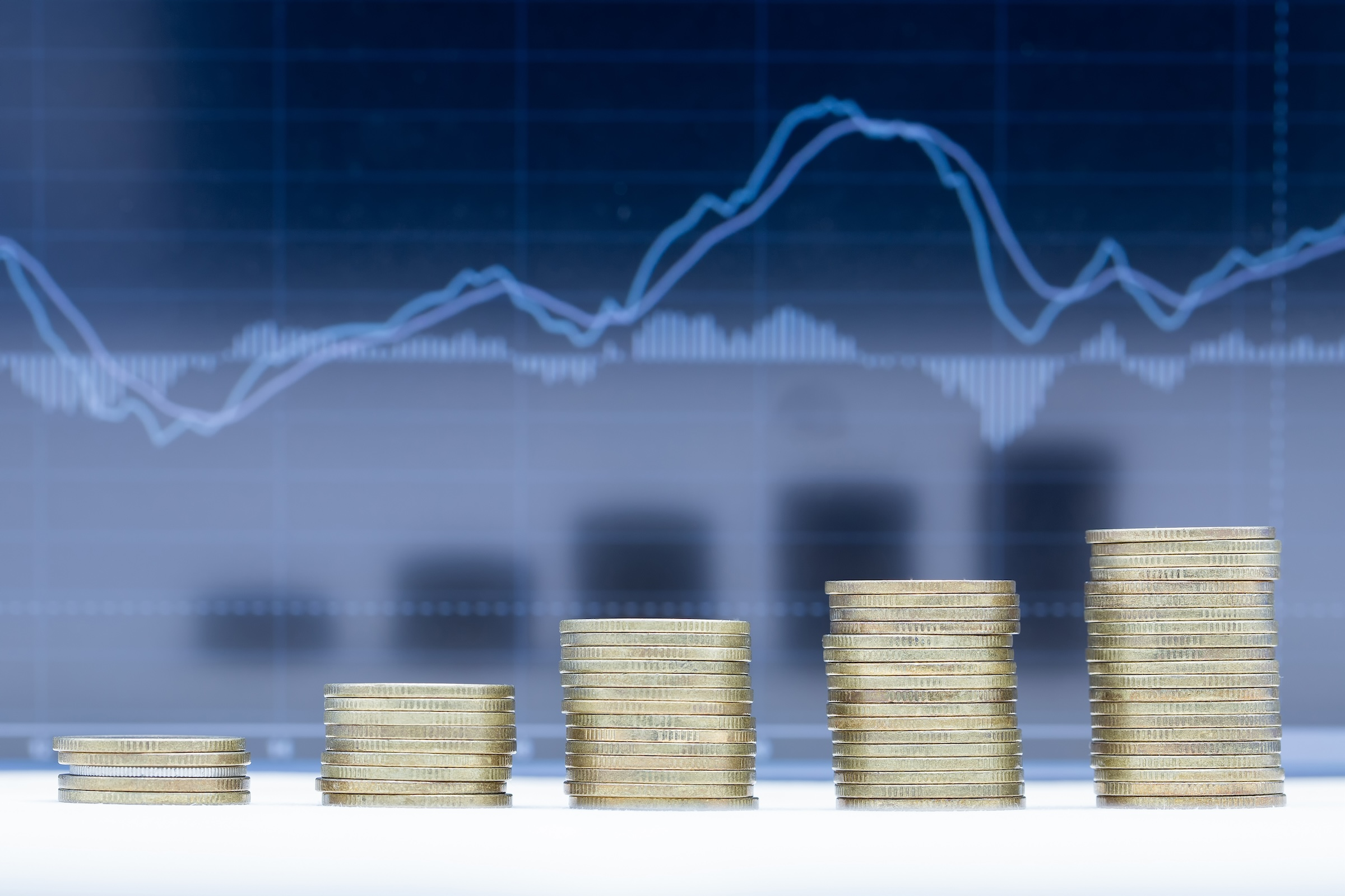 A stack of coins with a line graph above is used to illustrate that the economy showed mixed signals