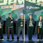 Top executives of Palawan Group led by Bobby L. Castro (holding flag), Founder and Chairman, lead the others in guiding the organization to new heights