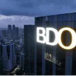 Facade shot of a BDO tower, taken at night, as the bank’s net income rises 4% to ₱63.1-B in first nine months of 2025