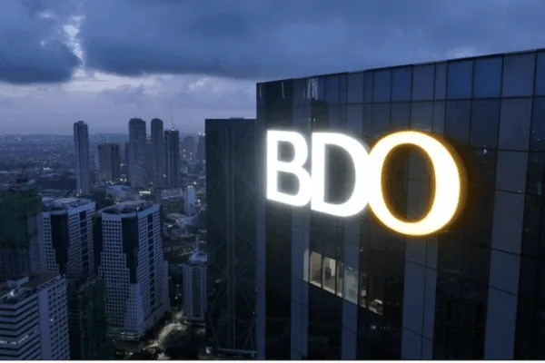 Facade shot of a BDO tower, taken at night, as the bank’s net income rises 4% to ₱63.1-B in first nine months of 2025