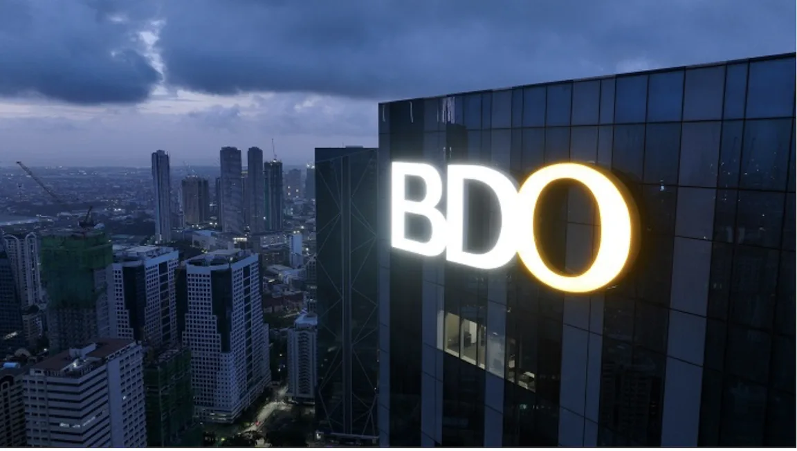 Facade shot of a BDO tower, taken at night, as the bank’s net income rises 4% to ₱63.1-B in first nine months of 2025