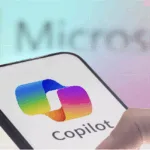 Image of a hand holding a mobile phone with the Microsoft Copilot app as the tech compamy unveils human-centered AI in it latest Copilot fall release