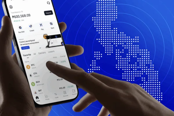 A mobile phone is used here to send money abroad (map of PH in background) as Coins.ph, BCRemit launch Stablecoin-powered remittance corridor to cut costs for OFWs