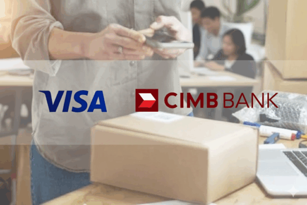 Logos of CIMB Bank and Visa on top of a photo of a man holding a mobile phone over a gift box