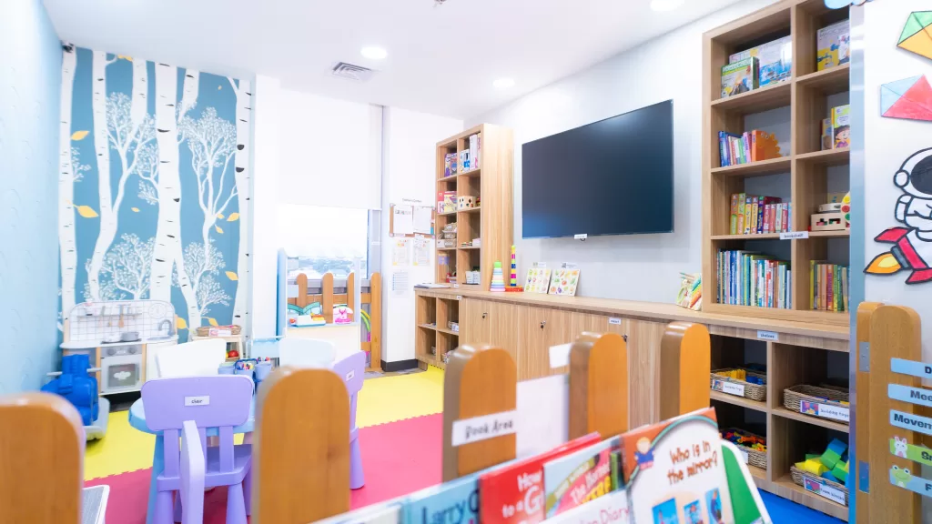 The play area at TaskUs Hiraya's Day Care in Las Piñas features colorful furniture, educational books, and toys designed to support employees with children.