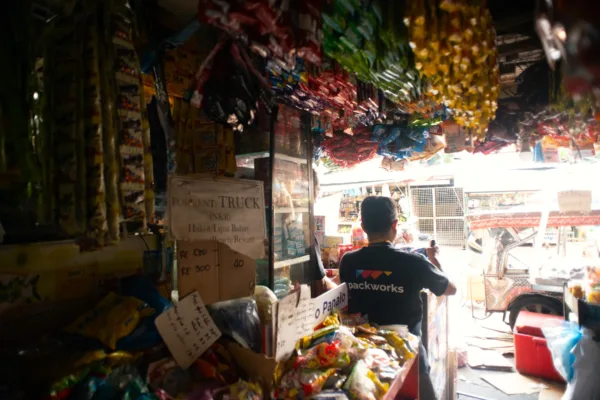 A man working in a sari-sari store is used to show how e-wallet use in these stores has since soared to 75%, driving grassroots digital transformation