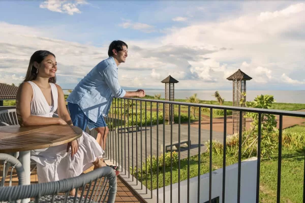 A husband and wife looking out from their terrace as Town Center at Seafront Residences ushers in a new era for coastal commerce