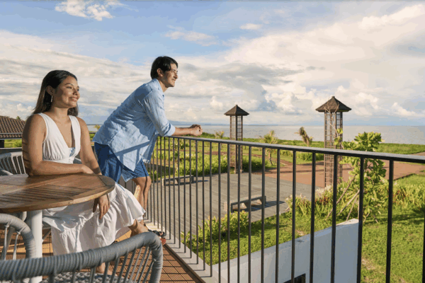 A husband and wife looking out from their terrace as Town Center at Seafront Residences ushers in a new era for coastal commerce