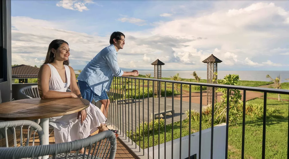 A husband and wife looking out from their terrace as Town Center at Seafront Residences ushers in a new era for coastal commerce