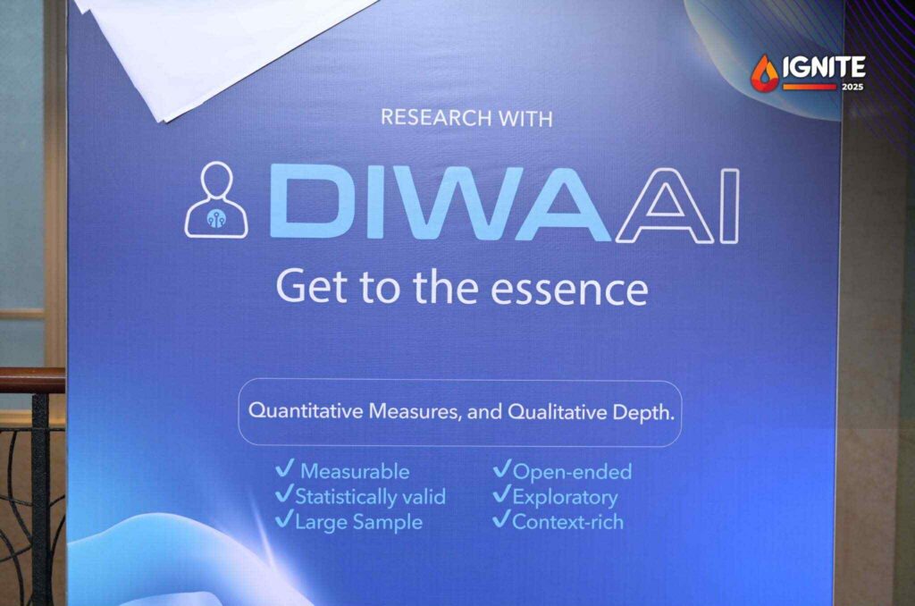 A blue event banner displaying the text "Research with Diwa AI – Get to the essence" with bullet points highlighting quantitative and qualitative research features, and an "IGNITE 2025" logo in the top right corner.