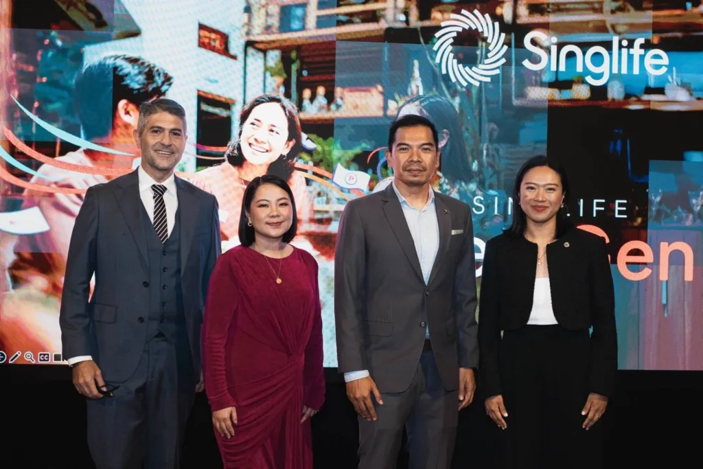 Photo shows (from left): host James Deakin, guest speaker Dette Zulueta of Millennial MomsPH, Lester Cruz, CEO of Singlife Philippines, and Ber Marquez, Head of Products and Propositions. With the Singlife logo in the background