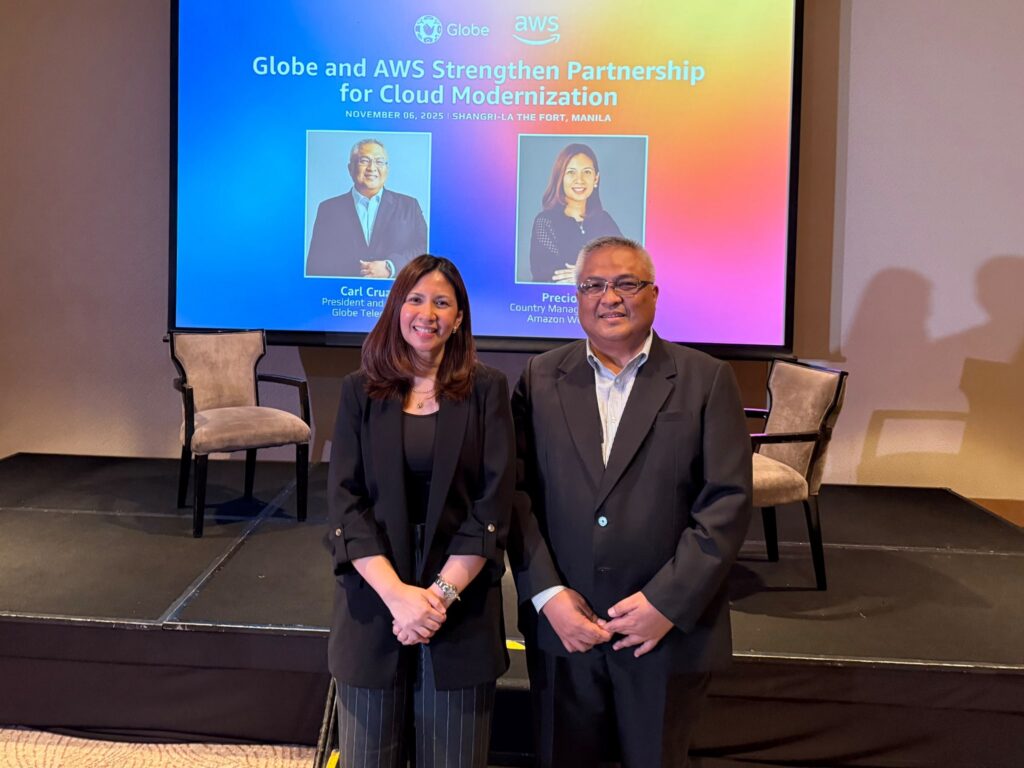 Two business executives stand on stage at the “Globe and AWS Strengthen Partnership for Cloud Modernization” event on November 6, 2025, in Manila, showcasing the collaboration between Globe Telecom and Amazon Web Services.