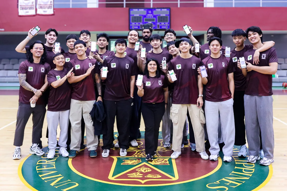 Executives of PalawanPay and members of the UP Fighting Maroons strike a pose after the fintech firm renewed its commitment to the UP Fighting Maroons, highlighting partnership and shared purpose