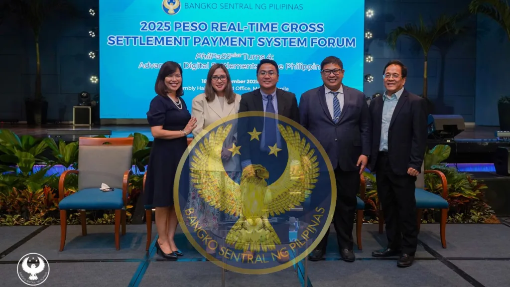 A group of people stands in front of a stage featuring 2025 Peso Real time Gross Settlement Payment System Forum. Along with the Bangko Sentral ng Pilipinas (BSP) logo