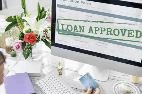 A computer monitor with the words "loan approved" as banks keeping lending standards steady in Q4; Fintech may gain edge in credit flexibility