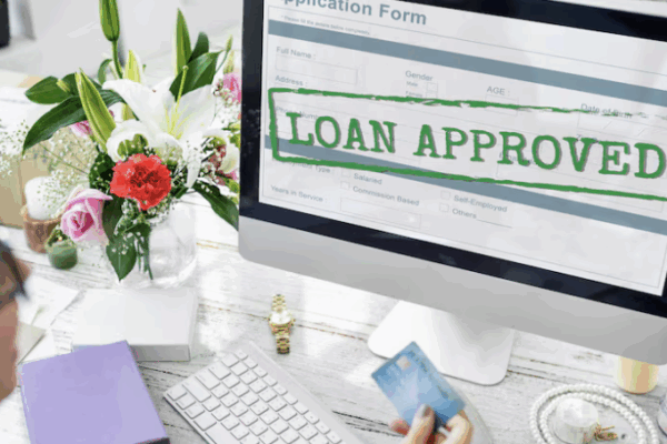 A computer monitor with the words "loan approved" as banks keeping lending standards steady in Q4; Fintech may gain edge in credit flexibility