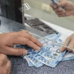 Money being exchanged during a banking transaction as the PH banking sector maintains strong growth as bank lending expands 10.5% in September