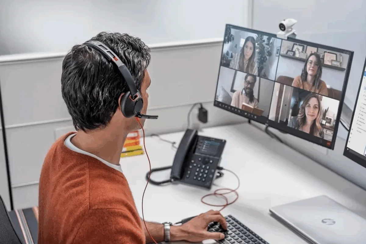 A man with a headset in from of his computer as part of the partner certification program at Fastly to boost security expertise