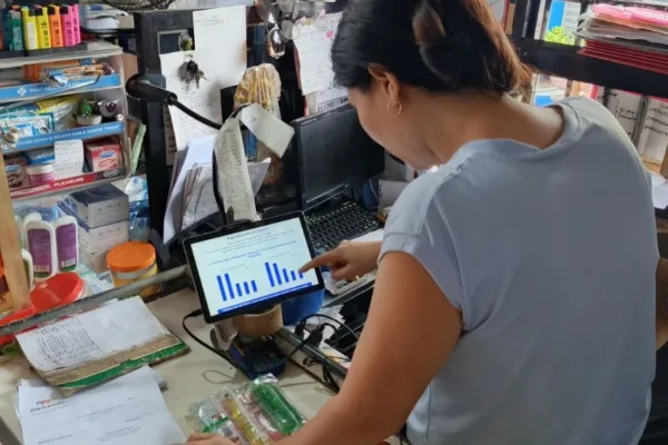 A store owner using AI is used to illustrate Packworks study findings that says AI helps sari-sari stores lift sales by 46%