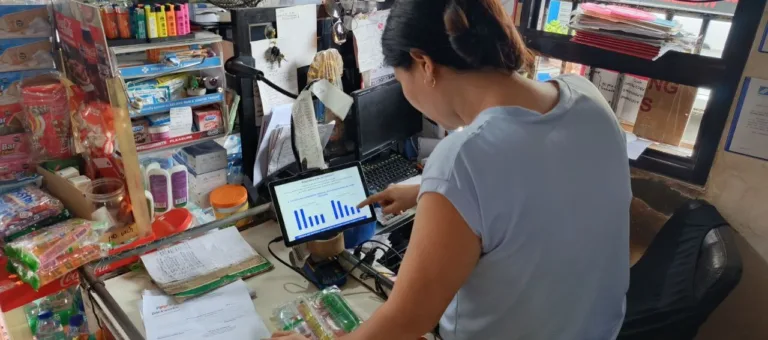 A store owner using AI is used to illustrate Packworks study findings that says AI helps sari-sari stores lift sales by 46%