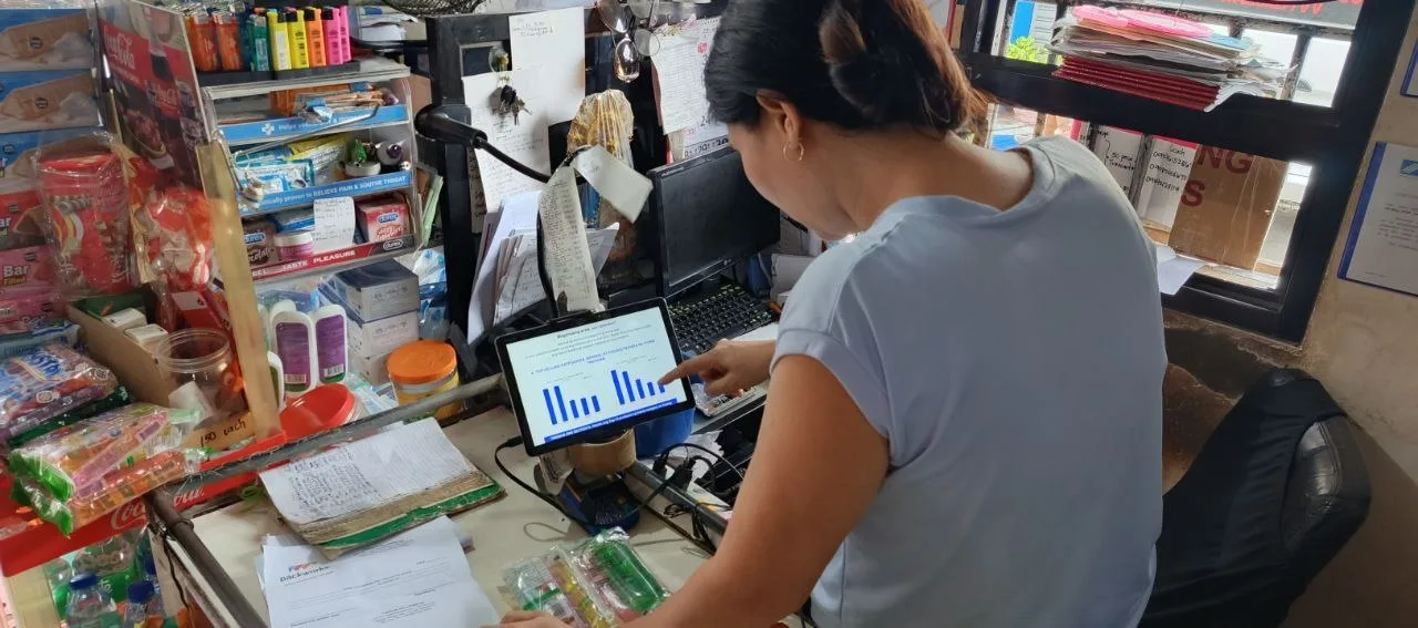 A store owner using AI is used to illustrate Packworks study findings that says AI helps sari-sari stores lift sales by 46%