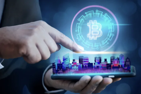 A man's fingers touches the screen to make Crypto transactions