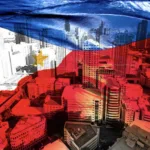 Flag of PH and tall buildings in financial district as BSP says economy on the right track