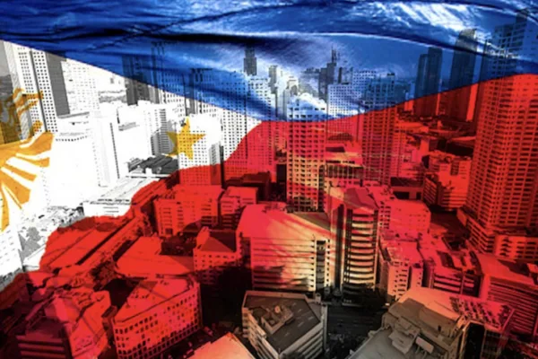 Flag of PH and tall buildings in financial district as BSP says economy on the right track