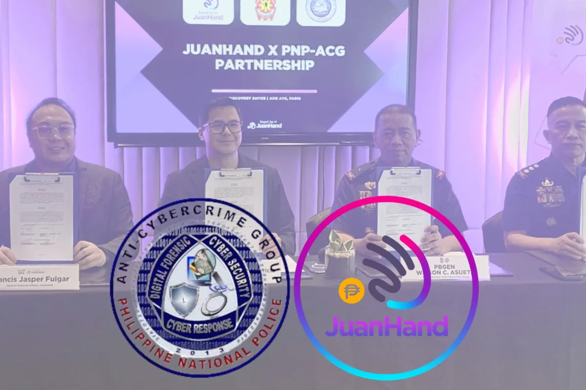 Four representatives from JuanHand and the Philippine National Police Anti-Cybercrime Group (PNP-ACG) sit at a table holding signed partnership documents during a formal signing ceremony in Manila. A screen behind them reads “JuanHand x PNP-ACG Partnership,” with the JuanHand and PNP-ACG logos displayed in the foreground, highlighting their collaboration to combat cybercrime in digital lending