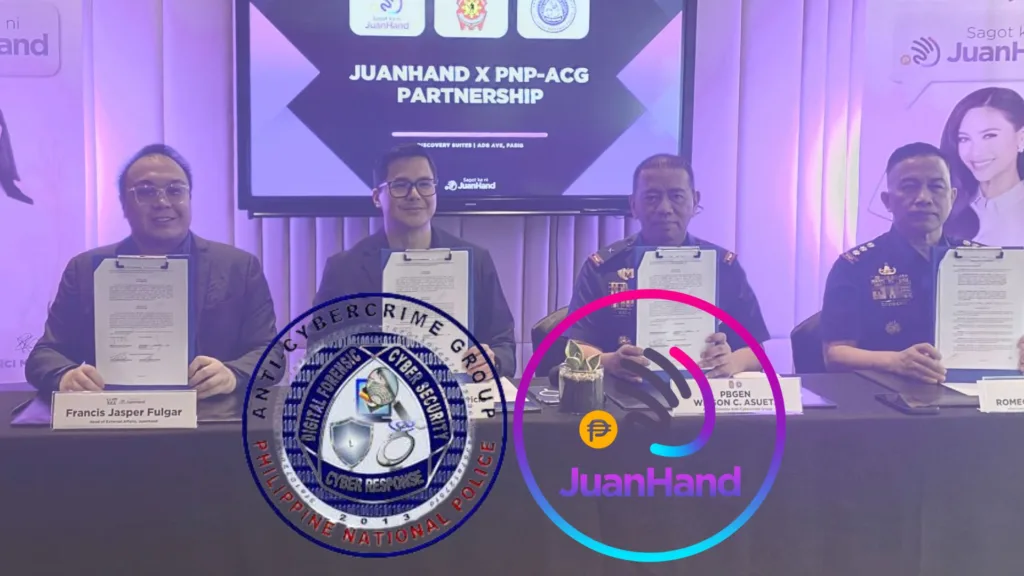 Four representatives from JuanHand and the Philippine National Police Anti-Cybercrime Group (PNP-ACG) sit at a table holding signed partnership documents during a formal signing ceremony in Manila. A screen behind them reads “JuanHand x PNP-ACG Partnership,” with the JuanHand and PNP-ACG logos displayed in the foreground, highlighting their collaboration to combat cybercrime in digital lending