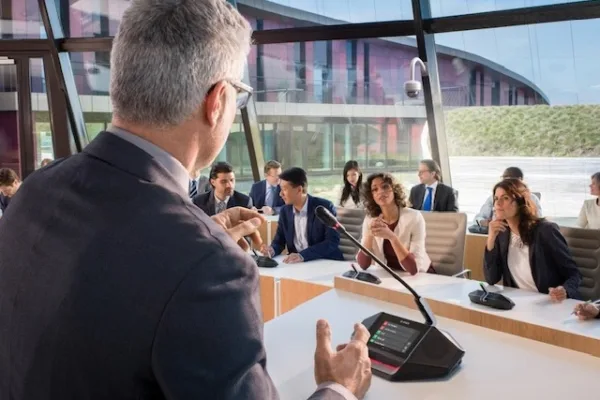 A man speaks using a mic at a conference as Bosch empowers digital governance in PH with cutting-edge DICENTIS conference solutions