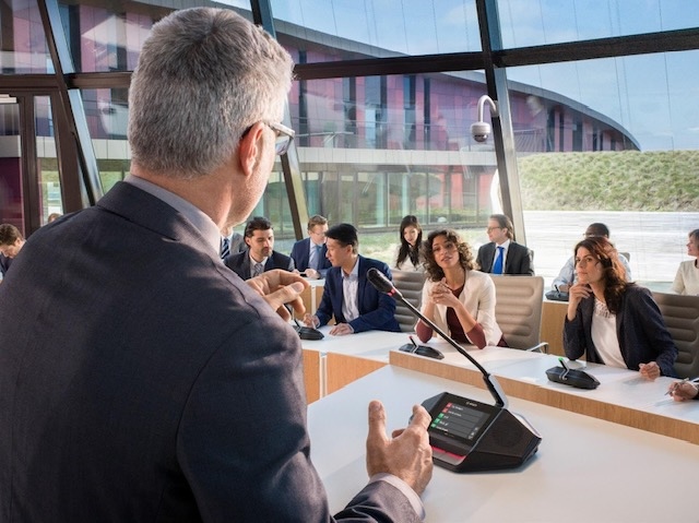 A man speaks using a mic at a conference as Bosch empowers digital governance in PH with cutting-edge DICENTIS conference solutions