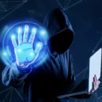 Image of a hacker in blue background to show why cybersecurity risks are rising as Filipinos go cashless