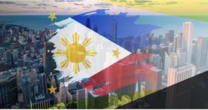 Image of a Philippine flag on top of tall buildings as the BSP sees 2025 inflation within target