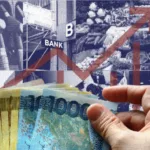 A hand holding wads of Philippine money as economy leans on remittances, services as global trade risks mount