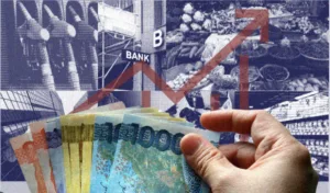 A hand holding wads of Philippine money as economy leans on remittances, services as global trade risks mount