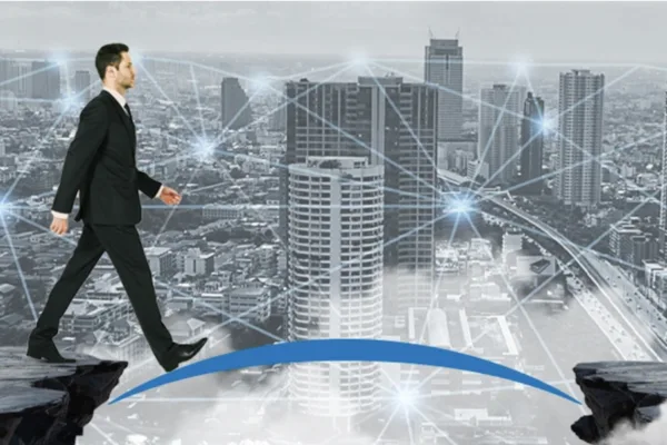 A man crossing a bridge as fintech puts MSMEs at the center, but access gaps still persist