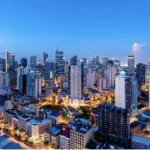 Image of tall buildings in the financial district as Metrobank sees moderate Philippine economic recovery in 2026 amid easing inflation, rate cuts