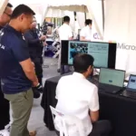 Pres. Ferdinand Marcos Jr. (seated) trying out the DepEd and Microsoft program called Microsoft Reading Progress, a Microsoft Learning Accelerator, and scored 98 percent.