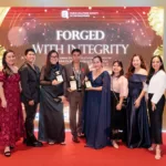 Executives and officers of the Palawan Group of Companies celebrate the group’s triple wins at the 61st ANVIL Awards