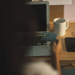 back view hand holding credit card