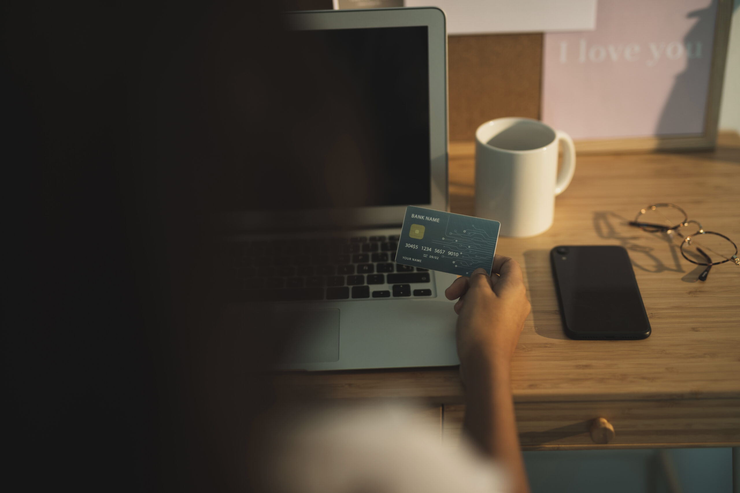 back view hand holding credit card scaled