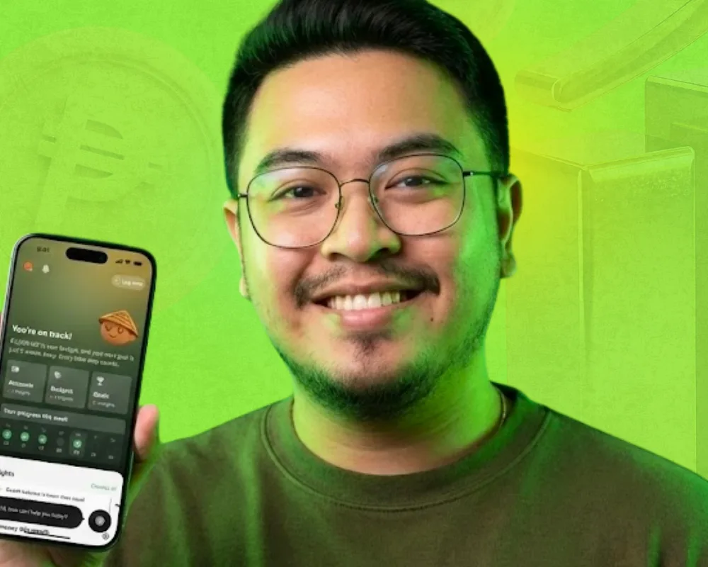 Theo Roque, Founder of Savio, holding the Savio app interface