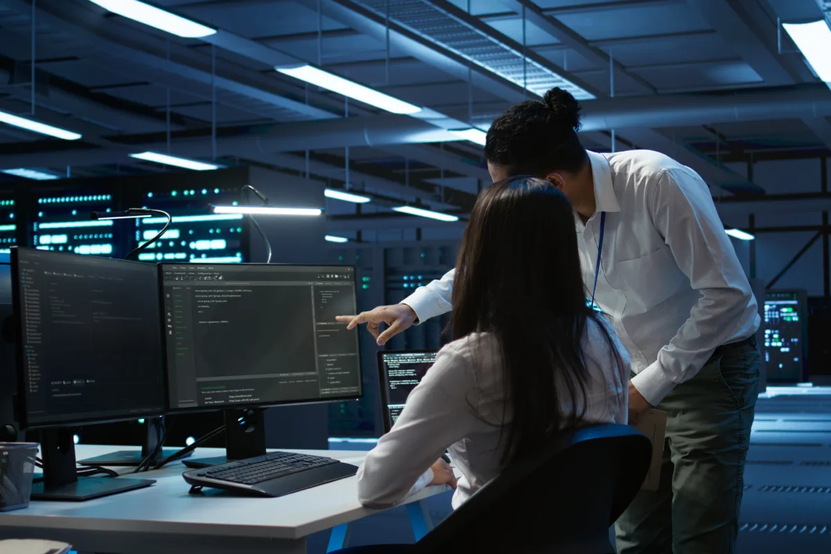 Computer scientists in data center managing and maintaining databases, ensuring data integrity and security. IT staff members updating server room systems using, camera B