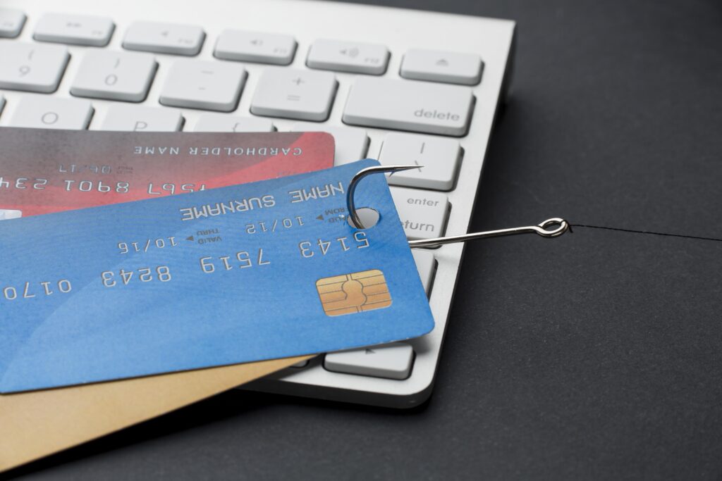 high angle keyboard with credit cards hook phishing