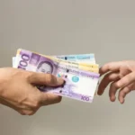 depositphotos 321852570 stock photo hand holding giving cash banknotes